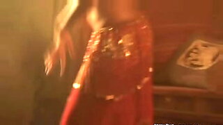 A sexy Indian brunette performs a hot belly dance, stripping completely.