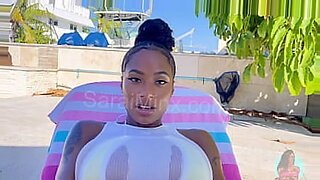 Big-boobed pornstar gets a poolside cumshot after a hot interracial dick-sucking session.